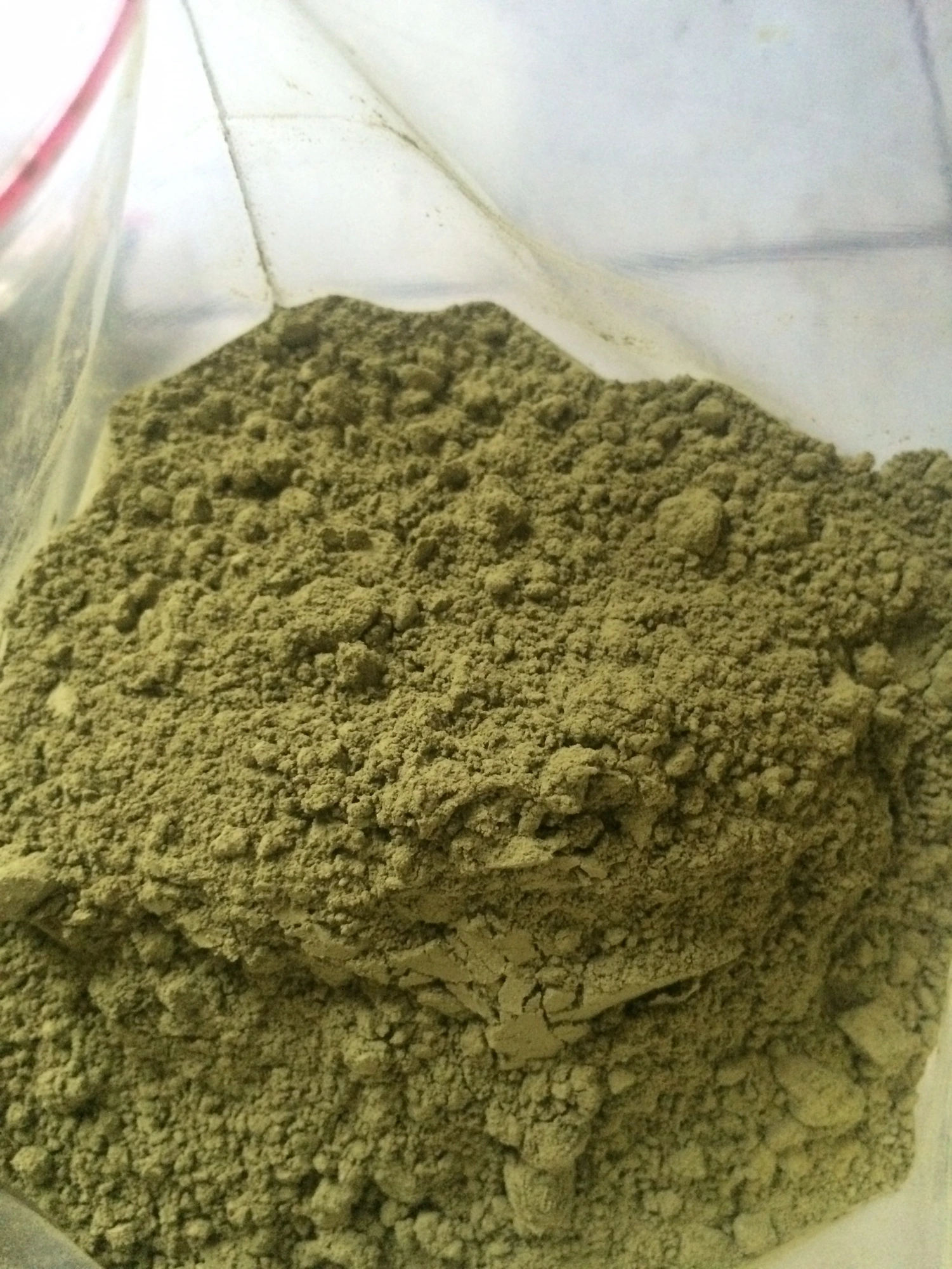 Close-up of fine green kratom powder